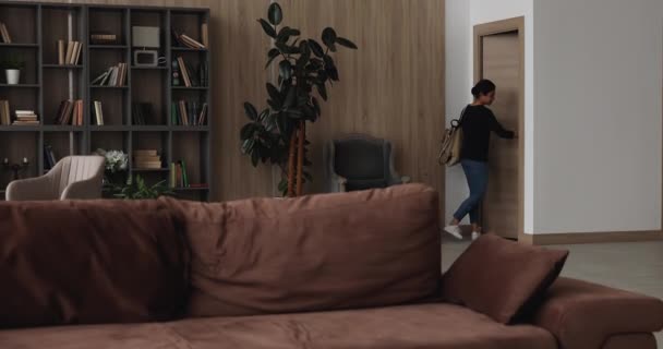 Indian woman sits on couch enjoys after work relaxation — Stock Video