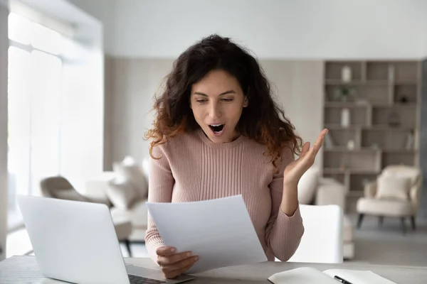 Excited Latin shocked by good news in paperwork letter — Stock Photo, Image