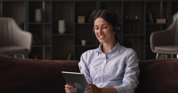 Mujer usar auriculares se comunica con uso familiar tableta y videocall — Vídeos de Stock