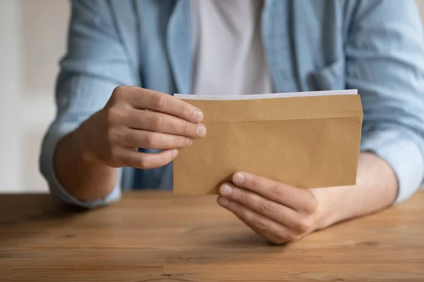 Close up young man getting business correspondence in envelope. — Stock Photo, Image