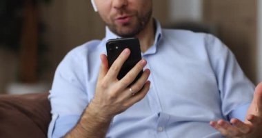 Yakın plan adam video konferans uygulaması kullanarak arkadaşla akıllı telefon konuşması yapıyor.