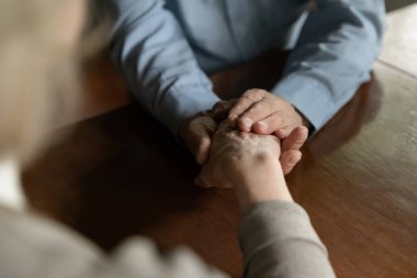 Elderly husband hold hand support comfort mature wife