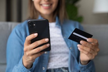 Close up young woman shopping in mobile application.