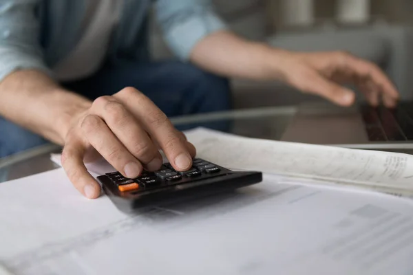 Close up young man managing household budget. — Stockfoto