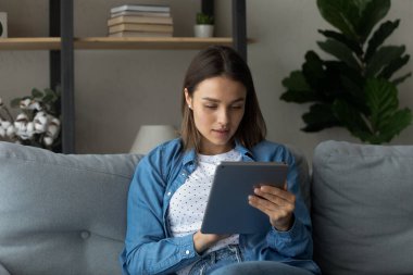 Happy attractive young woman using digital tablet.