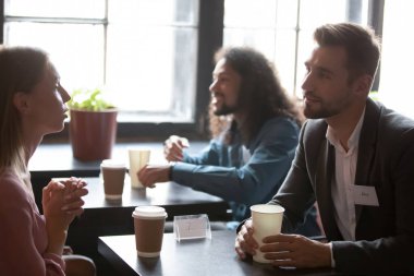 Interested young mixed race people attending speed dating.