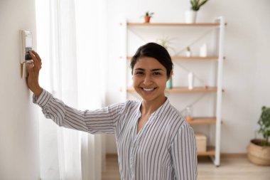 Portrait of smiling Indian woman use security system