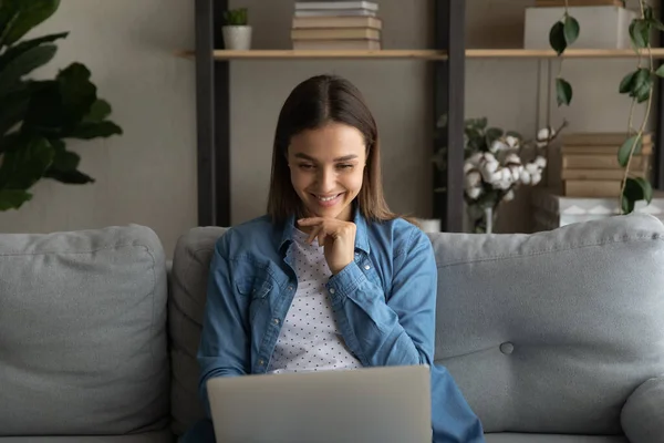 Happy young woman using computer at home. — Stockfoto