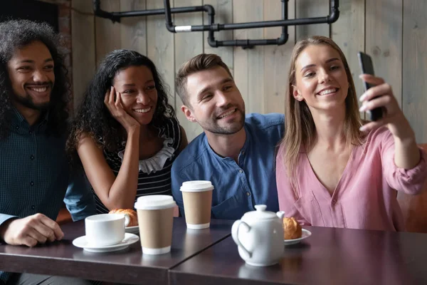Happy sincere multiracial couples posing for mobile selfie photo.