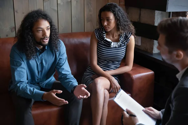Unhappy young african american family couple consulting with professional psychologist. — Stock Photo, Image