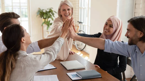 Happy multi-etnische werknemers groep geven high five op vergadering — Stockfoto