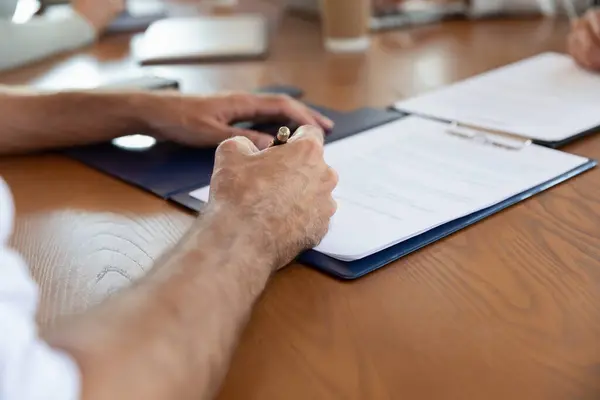 Close up businessman signing contract with pen at meeting — Stock Photo, Image