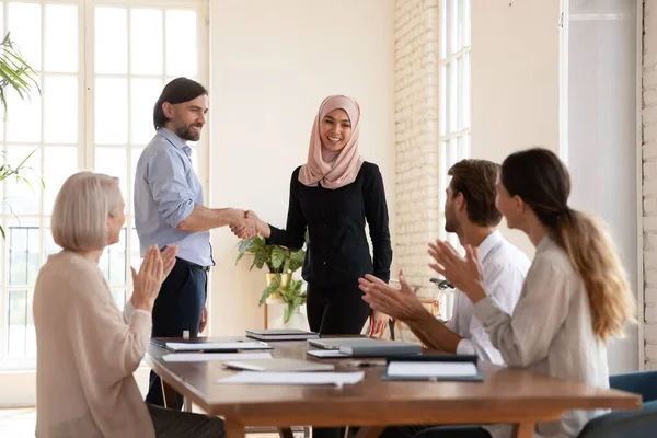 Teamleider schudden Aziatische moslim zakenvrouw hand, collega 's applaudisseren — Stockfoto