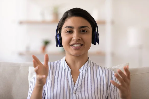 Portrait of Indian woman in headphones talk on video call — Stock Photo, Image