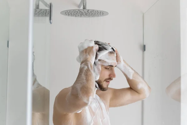 Calm relaxed handsome young man with muscular torso — Stock Photo, Image