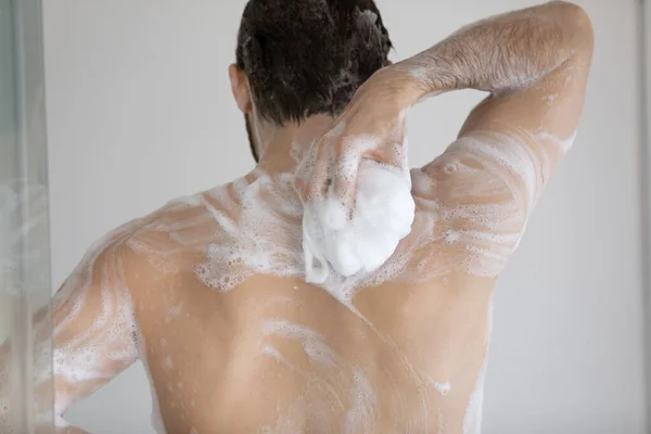 Back of handsome athletic wet young man taking shower — Stock Photo, Image