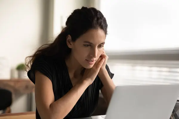 Jeune femme occupée à penser à travailler sur ordinateur portable — Photo
