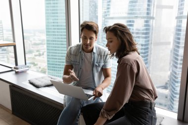 Ofisteki çevrimiçi proje üzerinde çalışan konsantre meslektaşlar.