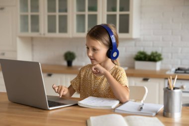 İlgi çekici küçük kız uzaktan çalışıyor..