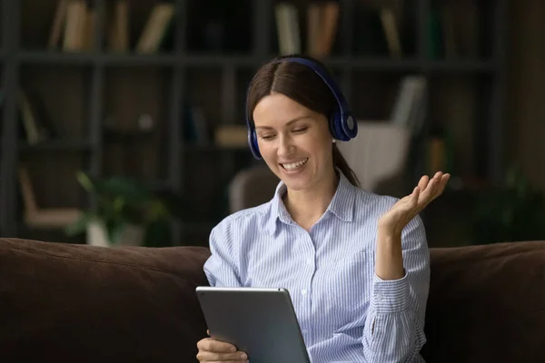 Smiling attractive young woman holding video call conversation using tablet. — Stock Photo, Image