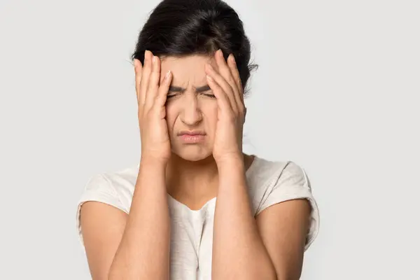 Unhappy Indian woman suffer from migraine overworking — Zdjęcie stockowe