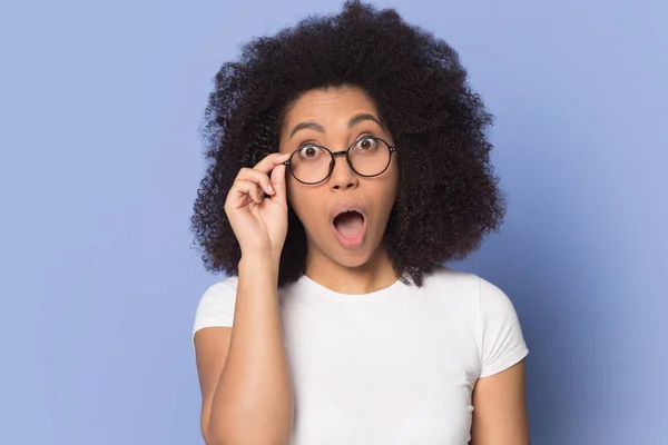 Amazed biracial woman in glasses shocked by sale offer — Stock Photo, Image