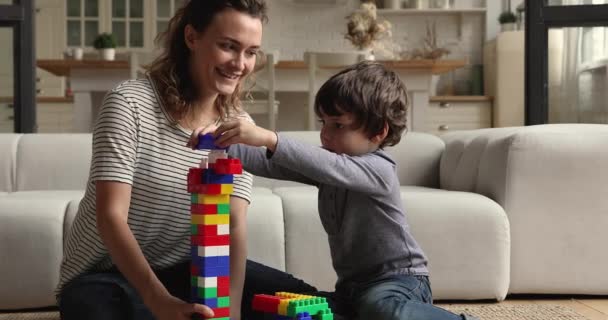 Happy millennial affectionate mother playing toys with little son. — Wideo stockowe