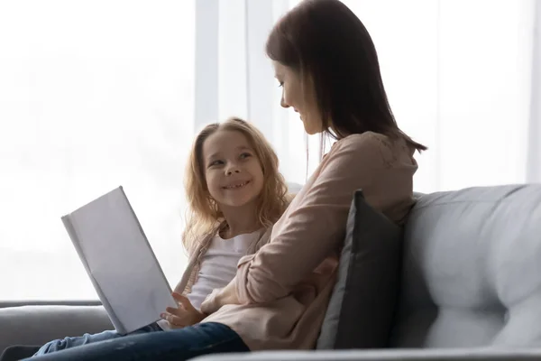 Schoolgirl discuss book with elder sister ask questions after reading