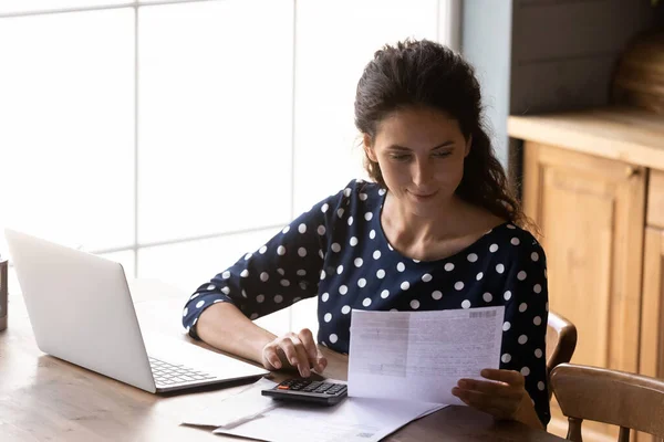 Focused young woman using calculating taxes, budget, costs, paying bill — Stock Photo, Image