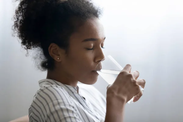 Close up African American woman enjoying drinking pure mineral water — Stock Photo, Image