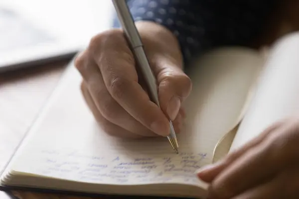 Hands of woman taking notes of online lecture webinar — Stock Photo, Image