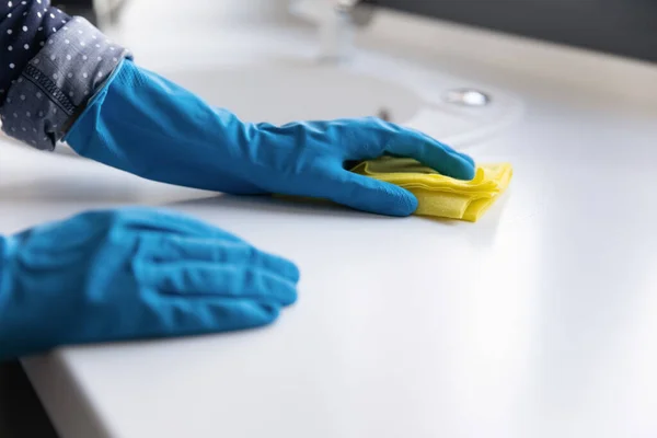 Housewife, cleaner, janitor wearing blue protective rubber gloves — стоковое фото