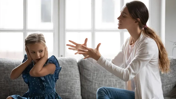 Small girl child ignore angry mom scolding — стоковое фото