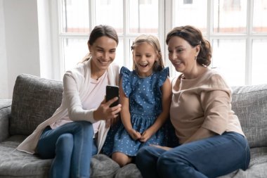 Üç nesildir gülümseyen kadınlar cep telefonlarıyla rahatlar.