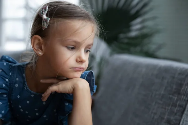 Unhappy little girl look in distance thinking — Stock Photo, Image
