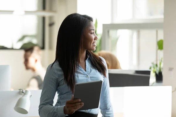 Happy thoughtful young business woman looking at window — Stock Photo, Image