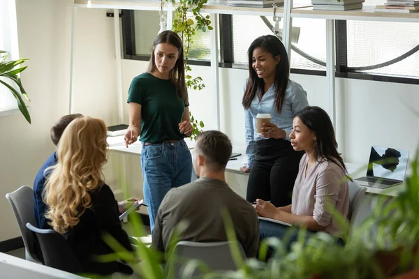 Millennial business team meeting and talking, discussing work project