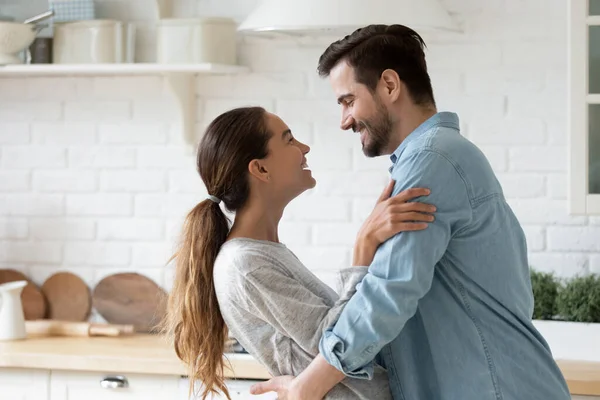 Beautiful couple in love dance in modern light kitchen — Stock Photo, Image