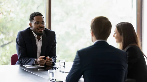 Confident banker, lawyer, manager giving consultation to clients on meeting — Stock Photo, Image