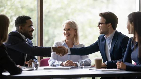 Happy multiethnic team members, conference participant, coworkers shaking hands — Stock Photo, Image