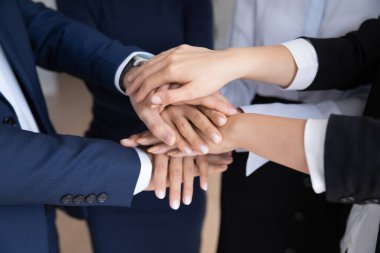 Ofis çalışanları topluluk el hareketi yapıyor.