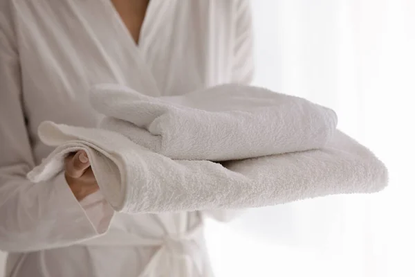 Young woman going to take shower holding soft terry towels — Stock Photo, Image