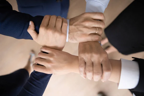 United business team holding wrists and making unbreakable hand square — Stock Photo, Image