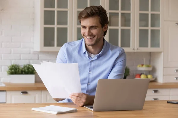 Excited millennial enterpreneur do paperwork at home office analyze report — Stock Photo, Image