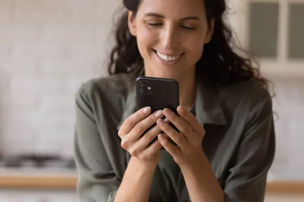 Positive young female engaged in virtual dating at phone app — Stock Photo, Image