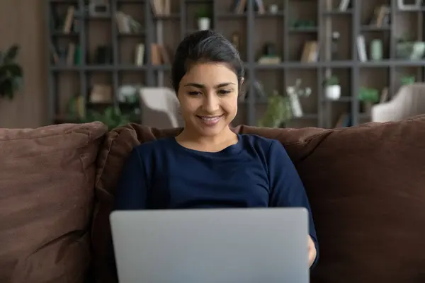 Smiling Indian woman use laptop working online — Stock Photo, Image