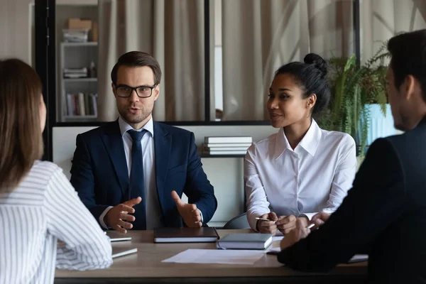 Confident male company leader talking to team at briefing — Stock Photo, Image