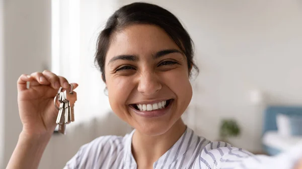 Head shot close up of excited Indian woman showing keys —  Fotos de Stock