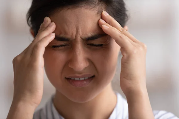 Head shot close up unhappy Indian woman feeling strong headache — Foto de Stock