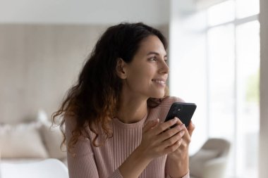 Gülümseyen Latin kadın internette cep telefonu mesajı kullanıyor